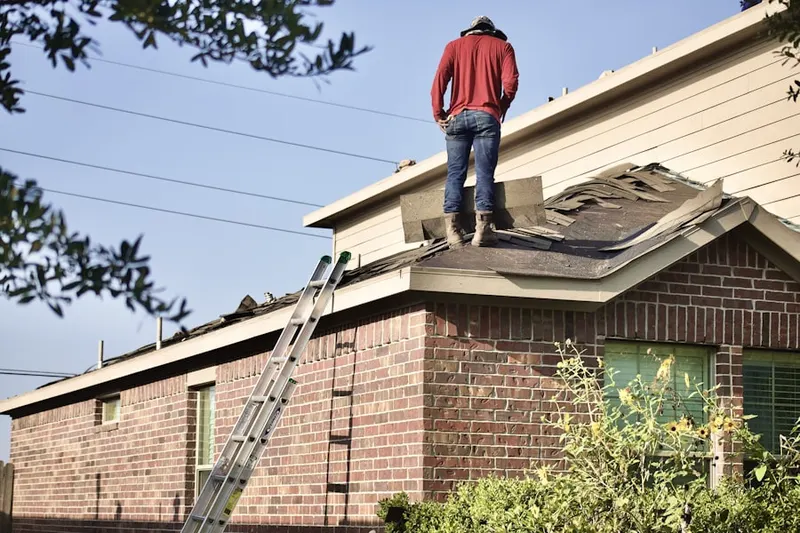 Professional roofer working on a residential roof in North Truro